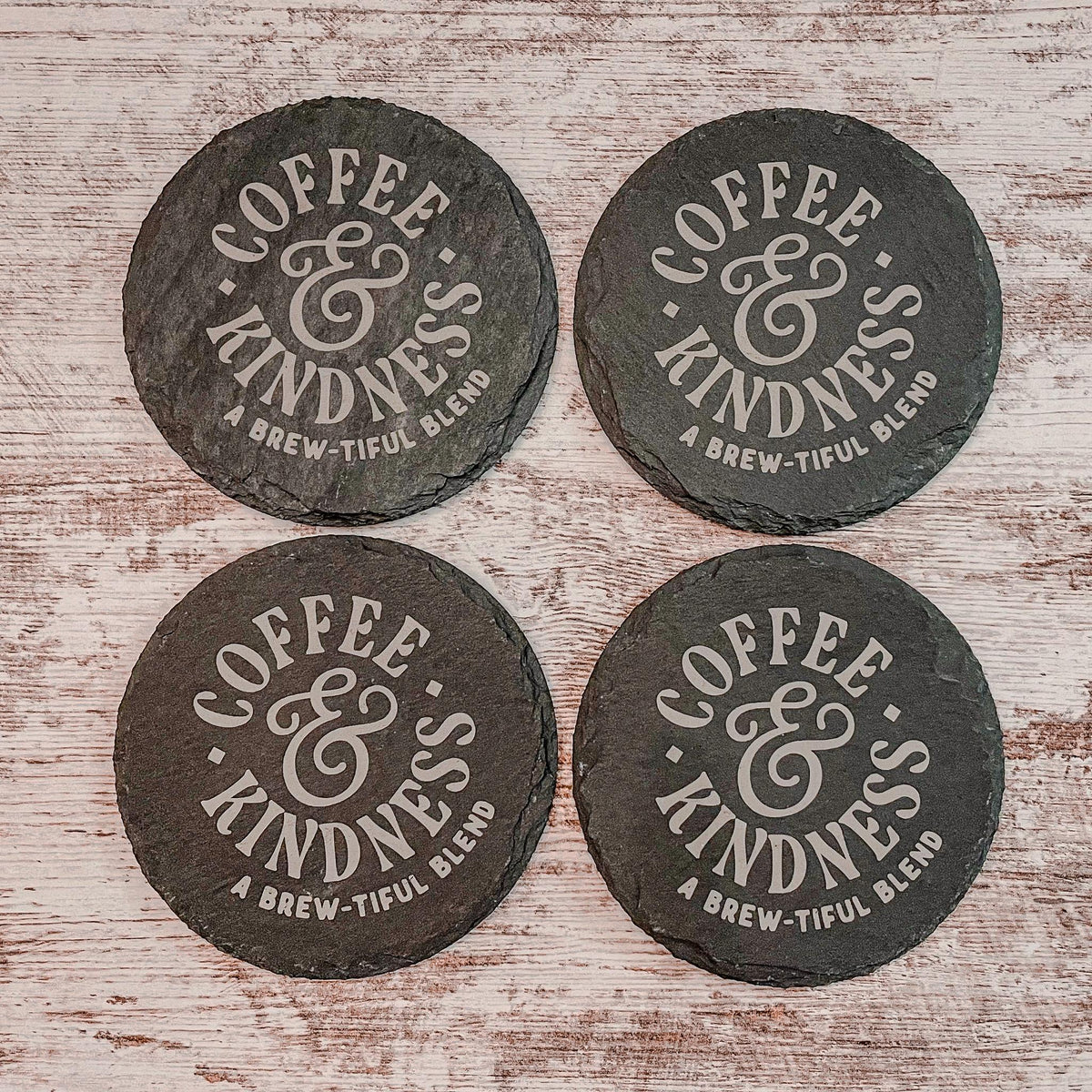 Coffee and Kindness a brew-tiful blend engraved on round slate coasters, set of 4
