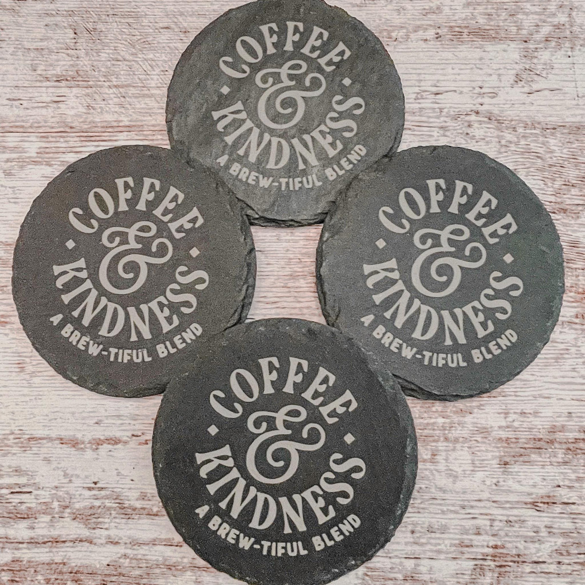 Coffee and Kindness a brew-tiful blend engraved on round slate coasters, set of 4