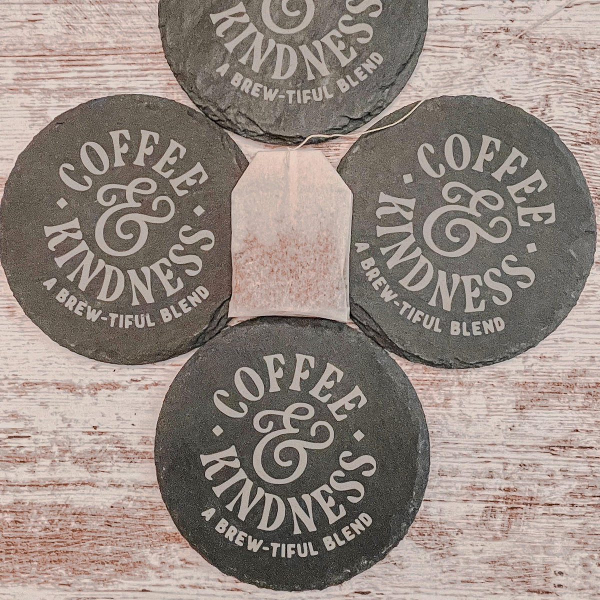 Coffee and Kindness a brew-tiful blend engraved on round slate coasters, set of 4