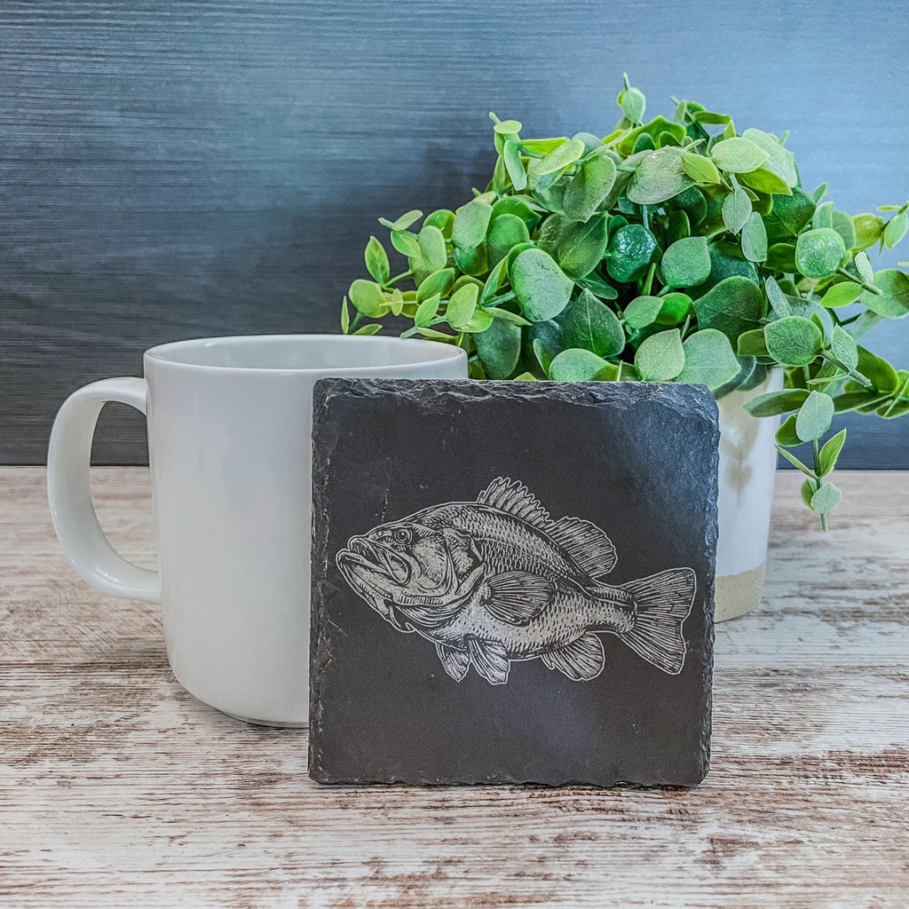 Slate coasters with bass fish laser engraved on them in 4 different scenes.